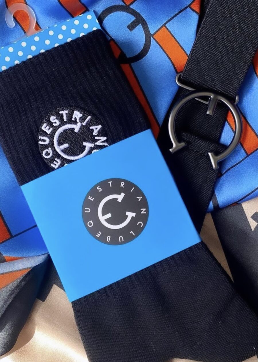 Close-up of blue and black guitar straps with circular logos and text.