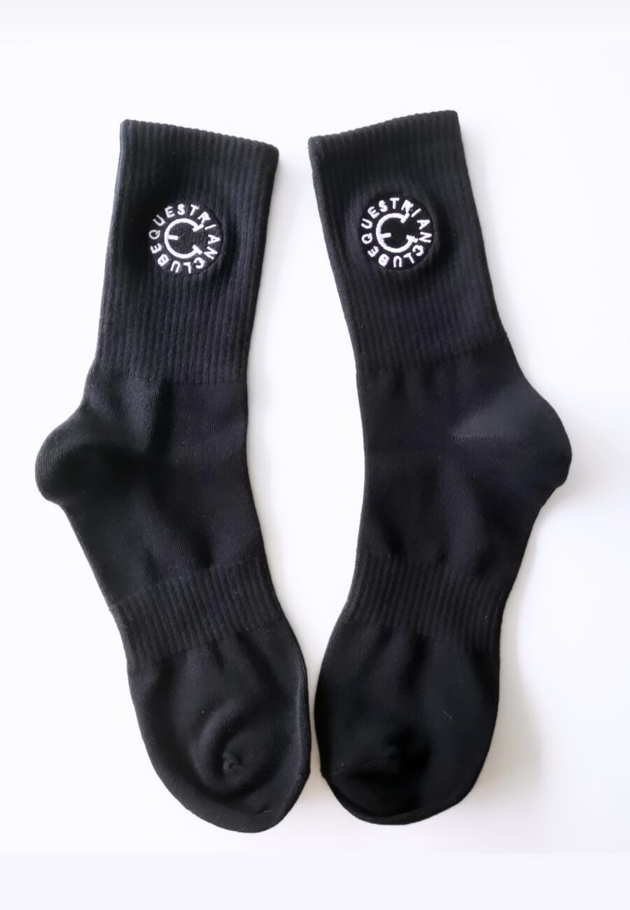Black socks with a white circular logo on the calf area.