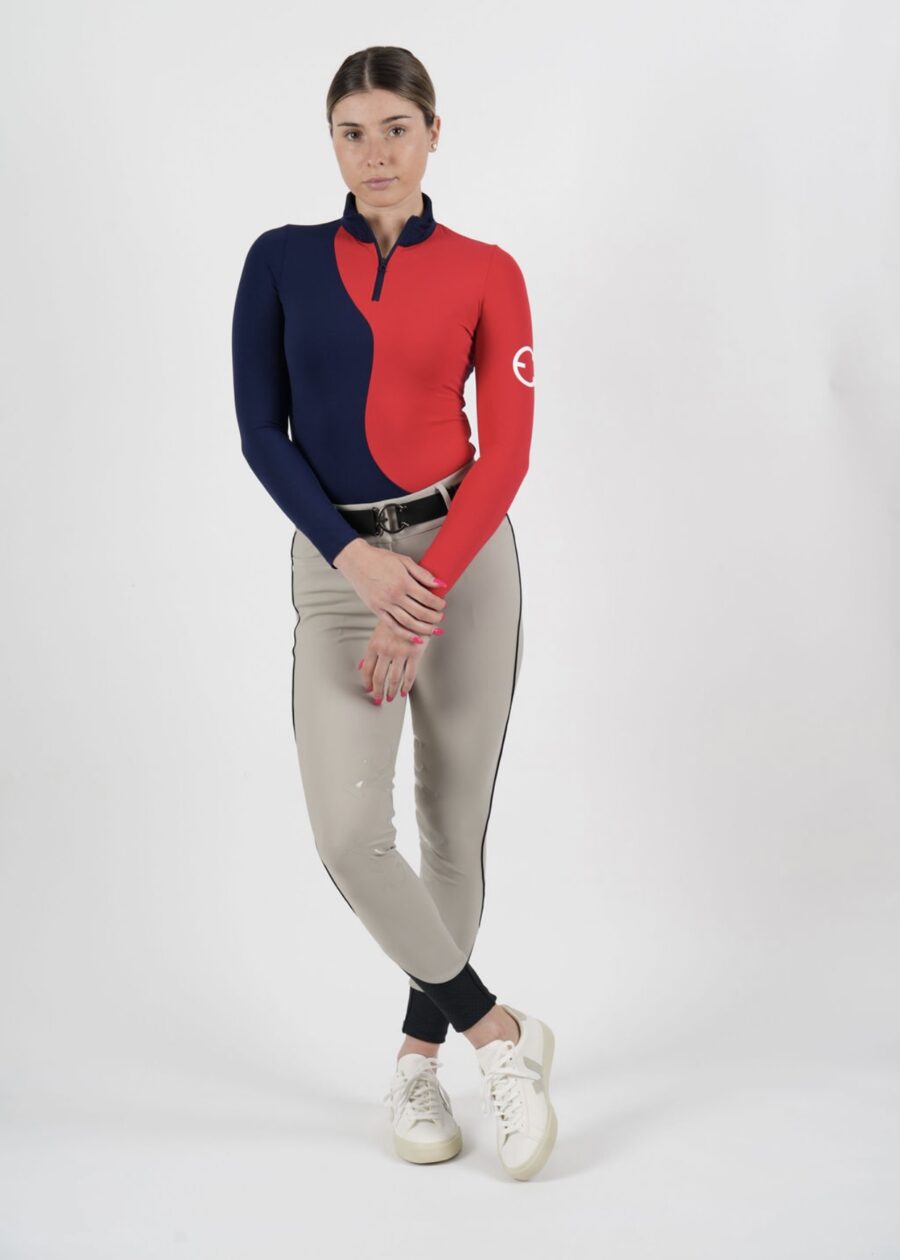 Person wearing a stylish half-red, half-navy jacket and beige pants.