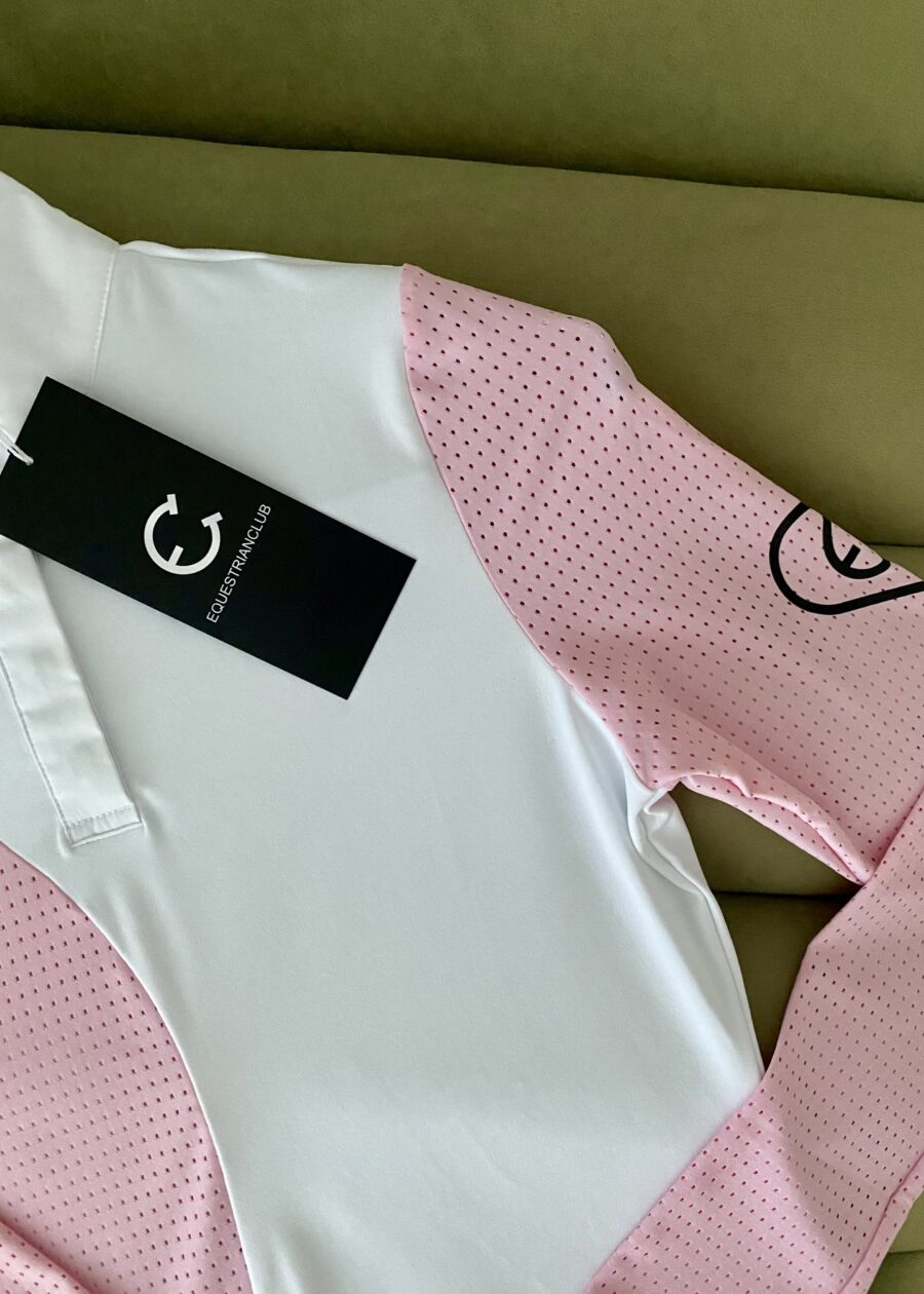 Close-up of a white and pink garment with a black tag.