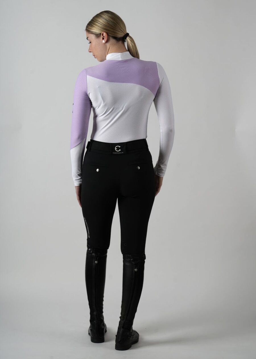 Person wearing a stylish purple and white long-sleeve top with black pants.