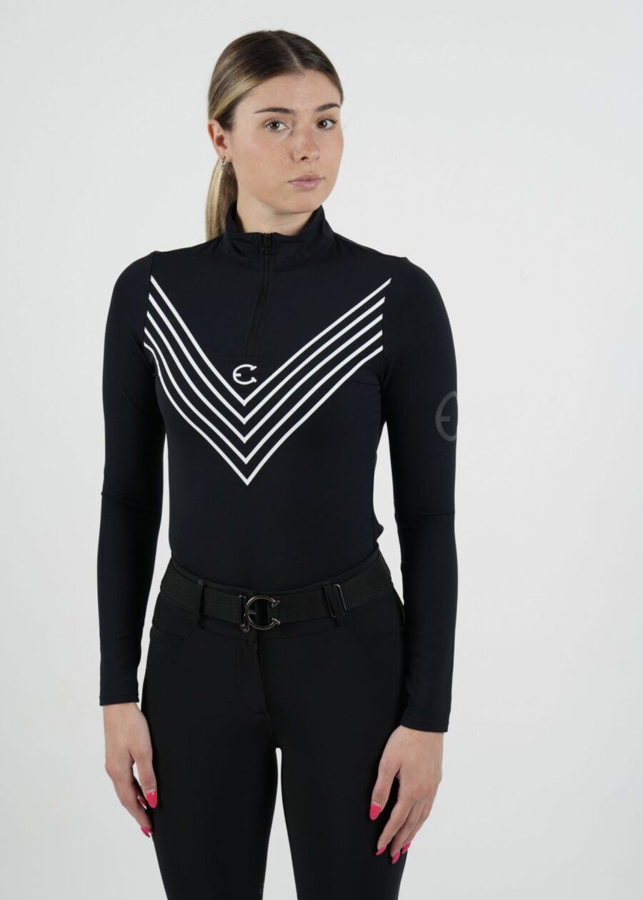 Person wearing a black turtleneck with white chevron stripes and black pants.