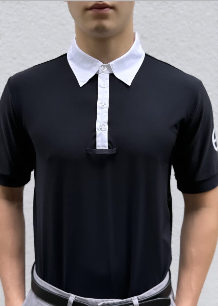 Man wearing a black polo shirt with a white collar and button placket.