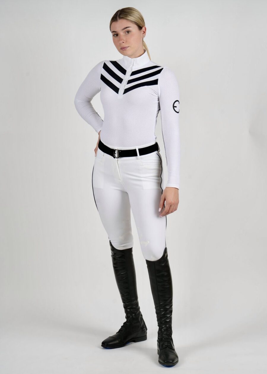 Person wearing a white futuristic uniform with black boots and belt.